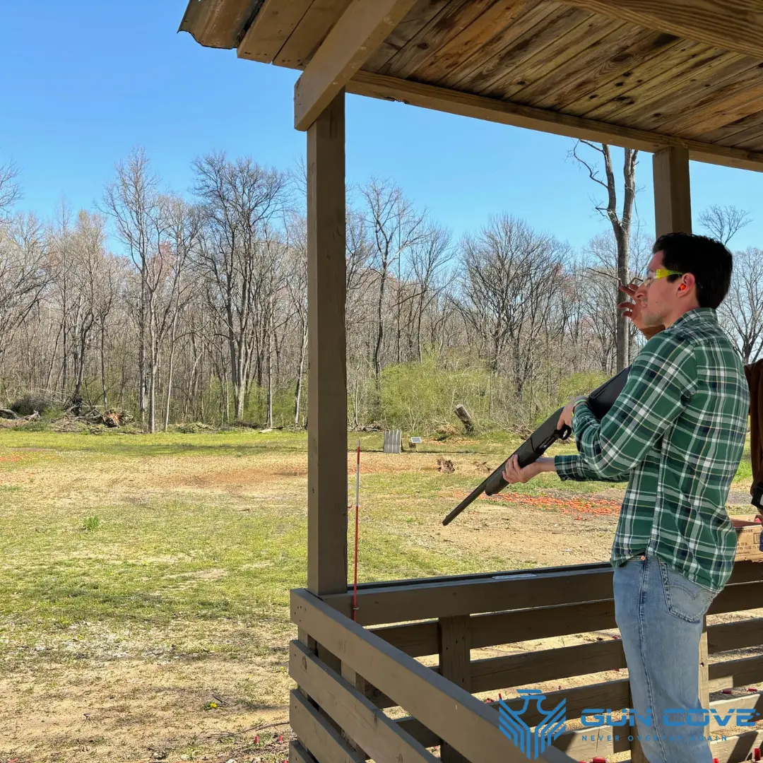 Attendee shooting a shotgun on the clay course